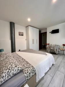 a bedroom with a large bed and a table at Case vacanza le vele in Desenzano del Garda