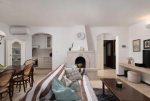 a living room with a couch and a fireplace at Heritage house Dvor in Sutivan