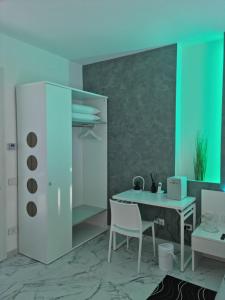 a room with a desk and a table and chairs at Lci Deluxe Rooms in San Cataldo