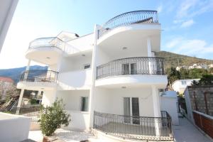 a white building with balconies on the side of it at Vile MonteMar in Herceg-Novi