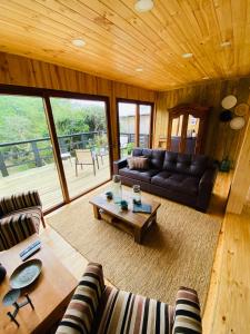 a living room with a couch and a coffee table at forest house - a pasos del mar in Pichilemu