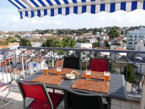 - une table sur un balcon avec 2 verres de bière dans l'établissement Cozy Pontaillac, à Vaux-sur-Mer