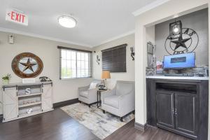 a living room with a fireplace and a desk and chair at Studio Apt: Heart of Houston in Houston