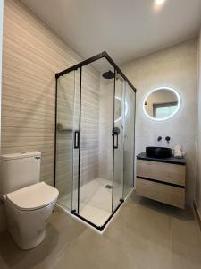 a bathroom with a shower and a toilet and a sink at Alojamiento rural FINCA AZUCENA SUITE in Conil de la Frontera