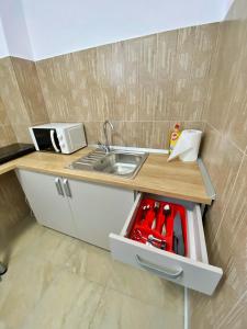 a small kitchen with a sink and a counter top at Central Park House in Cluj-Napoca