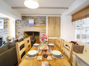 a dining room with a wooden table and chairs at Polgarth in Port Isaac