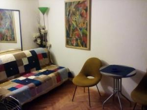 a bedroom with a bed and a chair and a table at Apartman MICHI in Sveti Juraj