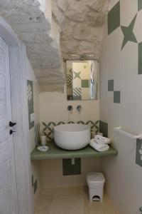 een badkamer met een wastafel en een toilet bij Trullo Vino & Amore in Alberobello