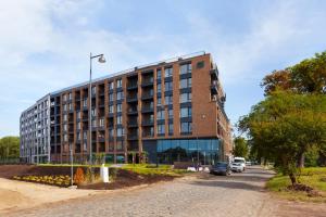 a brick building on a street with a street light at Elite Apartments Chlebova Premium in Gdańsk