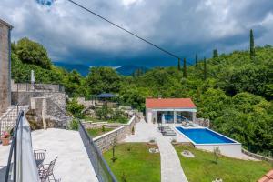 a villa with a swimming pool and a house at Villa Konavoski Miri in Gruda +42 photos