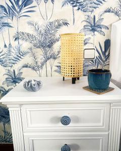 a white dresser with a blue and white wallpaper at Apartamento San Roque in Betanzos