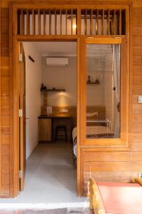 a small room with a bedroom with a desk at Village Vibes Lombok in Kuta Lombok