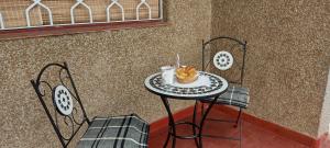 a table with a pastry on it with two chairs at CASA OLGUITA in Godoy Cruz