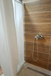 a shower curtain in a bathroom with a wooden wall at Freedom in Forest in Jajce