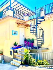 een huis met een wenteltrap ervoor bij Seeview rooftop house between Sorrento and Amalfi in Massa Lubrense