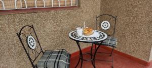 a table with a cup of coffee and a pastry on it at CASA OLGUITA in Godoy Cruz