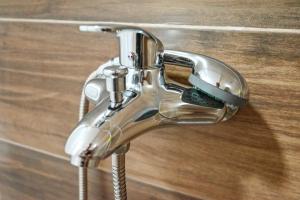 a close up of a chrome shower faucet at Freedom in Forest in Jajce
