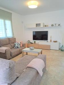A television and/or entertainment centre at Villa Las Tres J