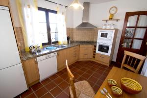 a kitchen with a sink and a stove top oven at Holiday Villa Campesina with Private Pool in San Bartolomé