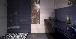 a bathroom with two sinks and a glass shower at Beach Apartments Ankora in Makarska +125 photos