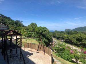a view of a garden with a gazebo at A23 - Conforto junto a natureza - Praia de Camburyzinho in São Sebastião