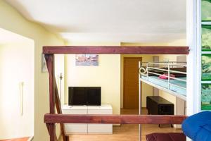 a room with a bunk bed and a television at Holiday House Esedra in Rome