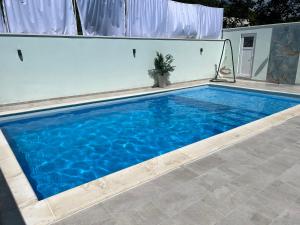 une grande piscine d'eau bleue dans l'établissement Villa Draga, à Mostar