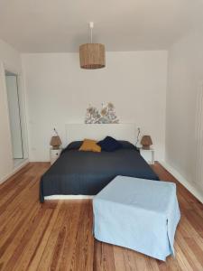a bedroom with a bed with a blue comforter at Casa Ilanga in Cannero Riviera