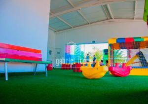 a play room with colorful benches and a playground at Lacqua Di Roma - O apartamento dos seus sonhos com desconto especial! in Caldas Novas