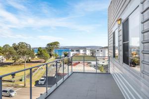 an apartment balcony with a view of a street at Waterview gem in Belmont