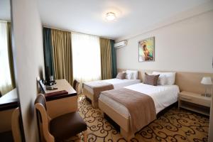 Postel nebo postele na pokoji v ubytování Hotel Beograd