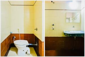 a bathroom with a toilet and a sink at Hotel Golden Dust ! Puri - ViDi Group of Hotels in Puri
