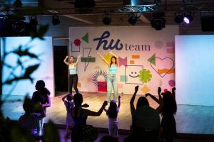 a group of people watching two women on a stage at Fabulous village in Casal Palocco