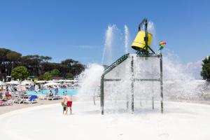 a water park with people playing in a water slide at Fabulous village in Casal Palocco