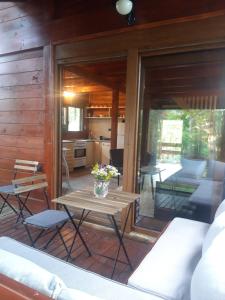 a living room with a table and a kitchen at Brvnara GAJ Divčibare in Požega +16 photos