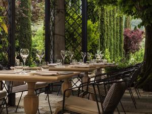 a table with wine glasses on a patio at Villa di Piazzano - Small Luxury Hotels of the World in Cortona