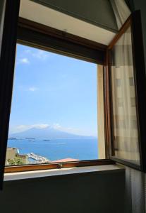a window with a view of the ocean at La Stella dei Venti B&B in Naples