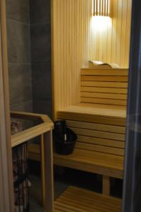 a small sauna with a bucket on a wooden bench at Три сосни in Kosiv +94 photos