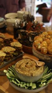 a table with a bowl of dip and some food at Karma Hostel in Martvili