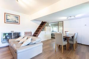 a living room with a couch and a table at Sailor House Near Lake in Pianello Del Lario