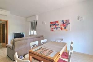 a living room with a table and a couch at S.Benedetto Terrace apartment in Peschiera del Garda