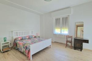 a bedroom with a bed and a desk and a piano at S.Benedetto Terrace apartment in Peschiera del Garda