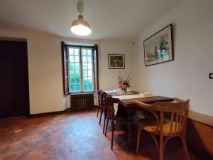 a dining room with a table and chairs and a window at Domaine de l'Ormerie Provins in Provins