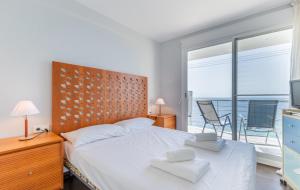 a bedroom with a bed and a television and a balcony at Mar de Moravit by Nora Nice in Moraira