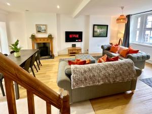 a living room with a couch and a table at Rye Court Cottages in Helmsley