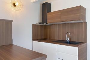a kitchen with a sink and wooden cabinets at Duplex à La Marina in Saint-Raphaël