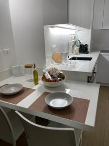 a kitchen counter with two chairs and a bowl of food at Dimora Dilù in Noci