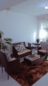 a living room with couches and a table at KMK APARTMENTS in Kitwe