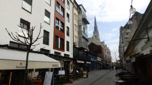 een straat met gebouwen en een kerk bij Bright Side Apartment in Novi Sad