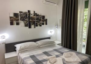 Postel nebo postele na pokoji v ubytování chiAma Hotel